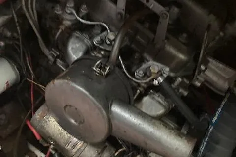 Slide: The Image of Engine of a 1985 Pearson 36-2 sailboat, showcasing mechanical components and wiring. - 12