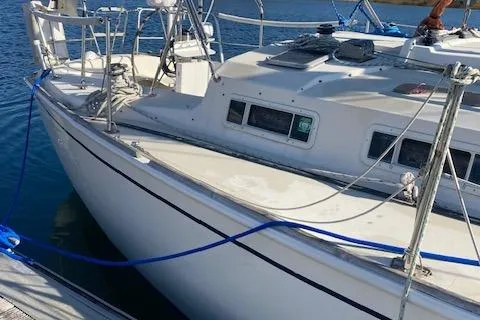 Slide: The Image of 1985 Pearson 36-2 sailboat docked, featuring sleek white hull and deck. - 2