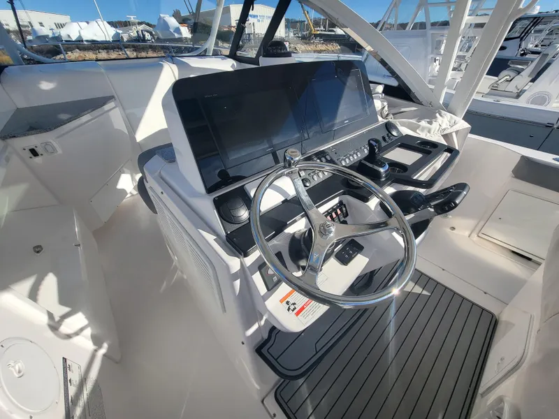 Slide: The Image of 2018 Everglades 360 LXC boat helm with modern controls and dual screens. - 13