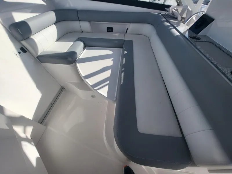 Slide: The Image of 2018 Everglades 360 LXC boat interior with gray and white cushioned seating. - 14