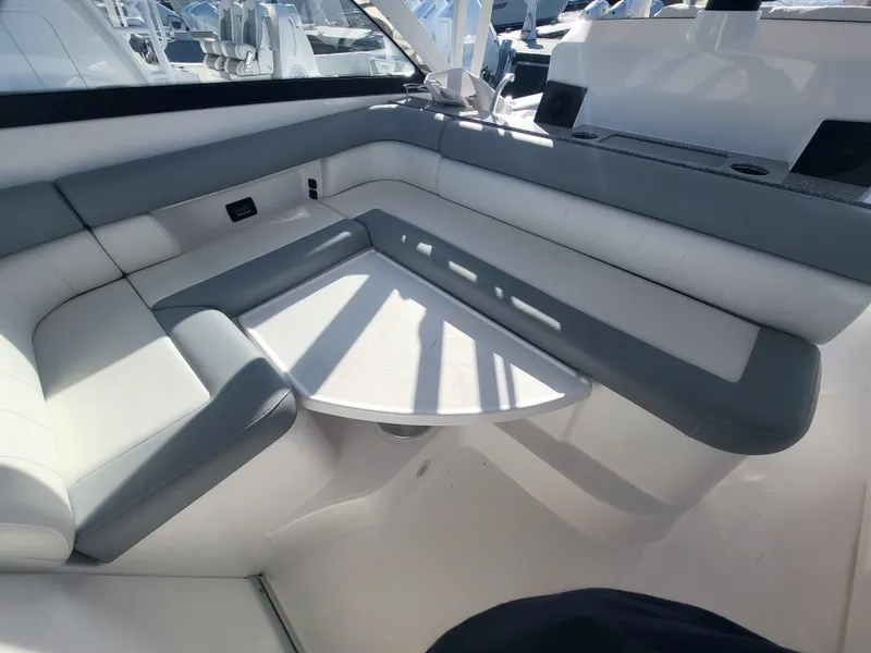 Slide: The Image of 2018 Everglades 360 LXC boat interior seating area with table. - 15