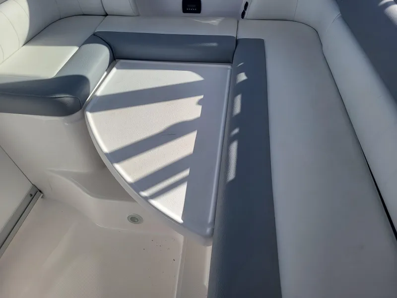 Slide: The Image of 2018 Everglades 360 LXC boat interior seating area with white and gray upholstery. - 16