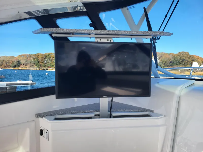 Slide: The Image of Flat-screen TV on 2018 Everglades 360 LXC boat with scenic water view. - 17