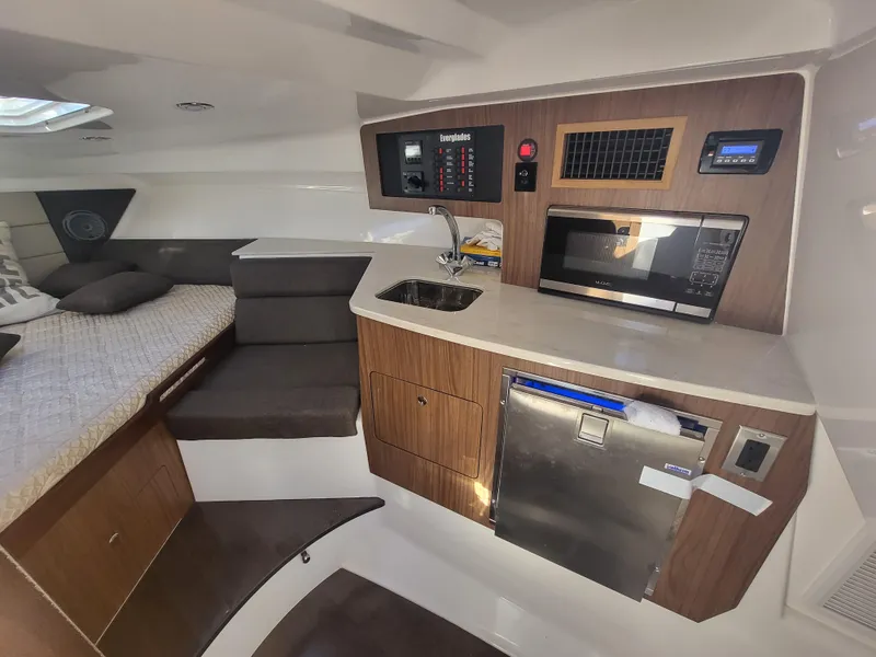 Slide: The Image of 2018 Everglades 360 LXC cabin with kitchenette, microwave, sink, and bed. - 19