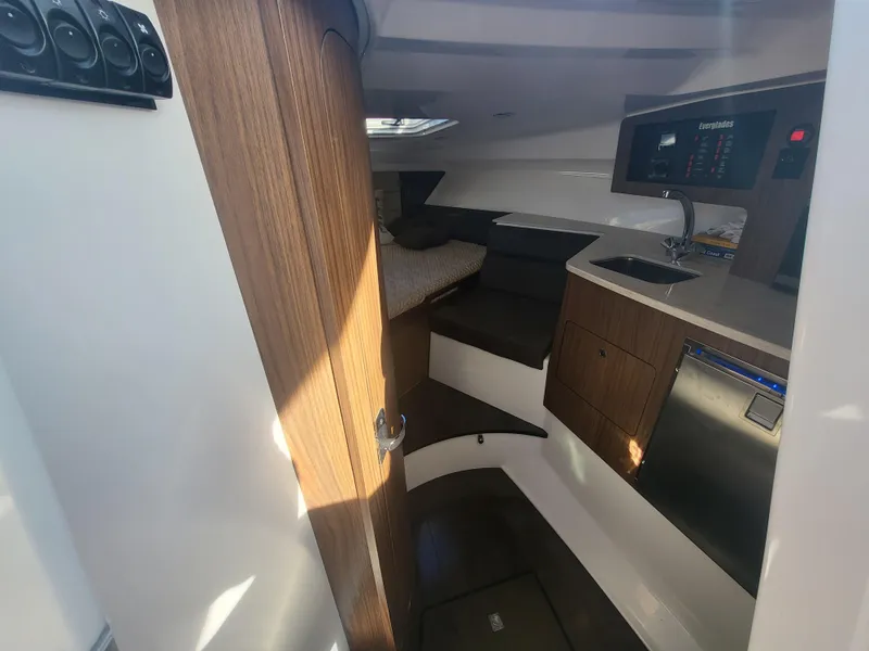 Slide: The Image of Interior cabin of 2018 Everglades 360 LXC boat with wood finish and modern amenities. - 20