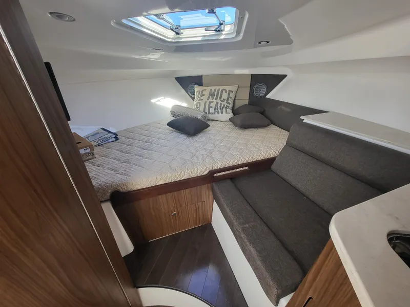 Slide: The Image of 2018 Everglades 360 LXC cabin interior with bed, skylight, and seating area. - 21