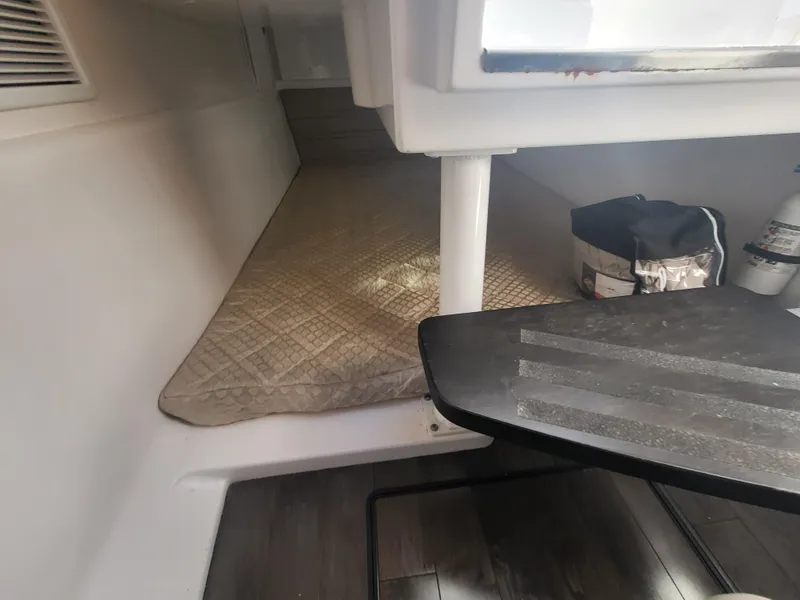 Slide: The Image of Interior cabin of 2018 Everglades 360 LXC boat with mattress and storage. - 27