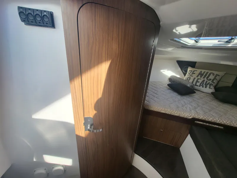 Slide: The Image of Interior cabin of 2018 Everglades 360 LXC boat with wooden door and cozy bed. - 30
