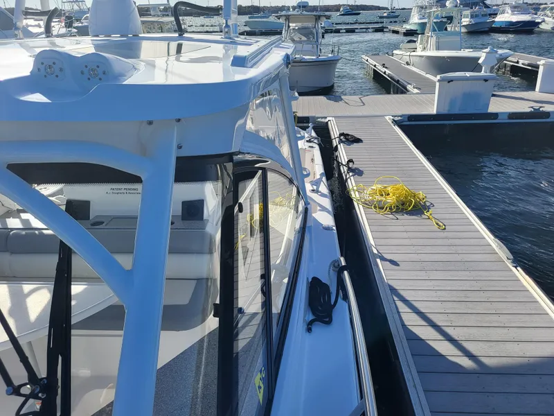 Slide: The Image of 2018 Everglades 360 LXC boat docked at a marina. - 35