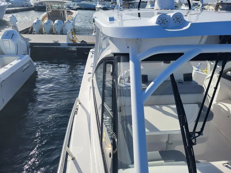 Slide: The Image of 2018 Everglades 360 LXC boat docked at a marina on a sunny day. - 36