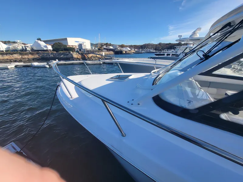 Slide: The Image of 2018 Everglades 360 LXC boat docked at a marina on a sunny day. - 40