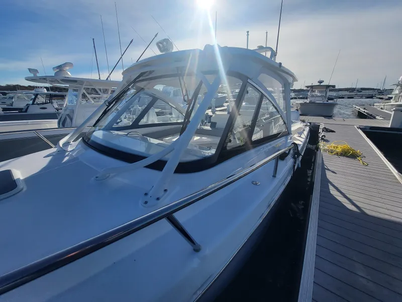 Slide: The Image of 2018 Everglades 360 LXC boat docked at marina under bright sunlight. - 41