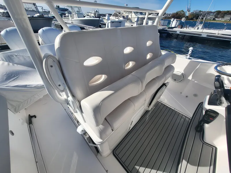 Slide: The Image of 2018 Everglades 360 LXC boat interior with white cushioned seating. - 47