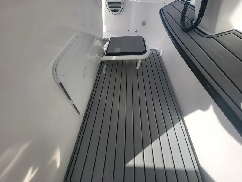 Slide: The Image of 2018 Everglades 360 LXC boat interior with gray flooring and seating. - 49