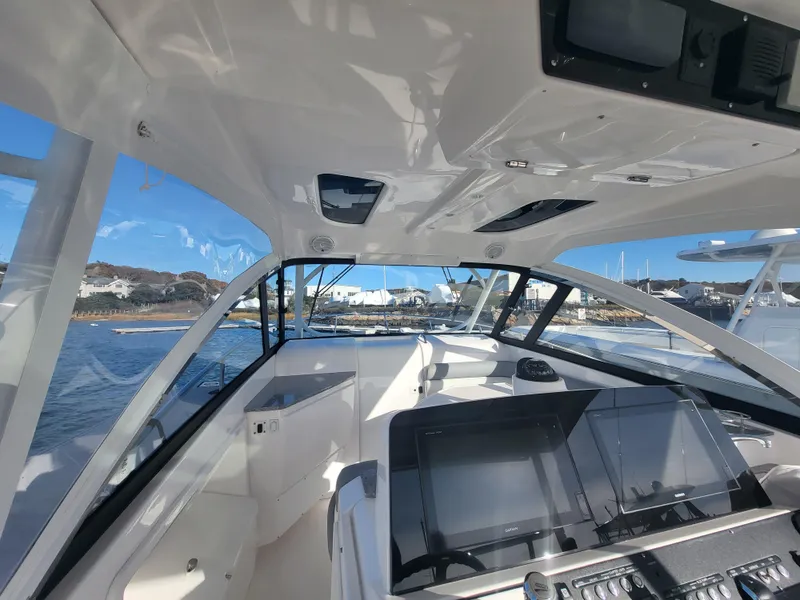 Slide: The Image of Cockpit view of 2018 Everglades 360 LXC boat on water. - 9