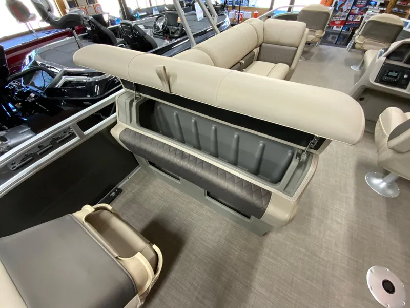 Slide: The Image of 2024 Sun Tracker Fishin' Barge 20 DLX interior with open storage compartment. - 12