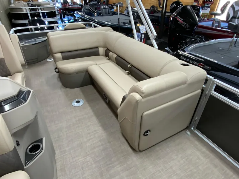 Slide: The Image of 2024 Sun Tracker Fishin' Barge 20 DLX interior with beige seating and modern design. - 8