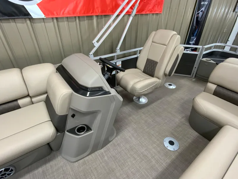 Slide: The Image of 2024 Sun Tracker Fishin' Barge 20 DLX interior with beige seating and helm. - 9