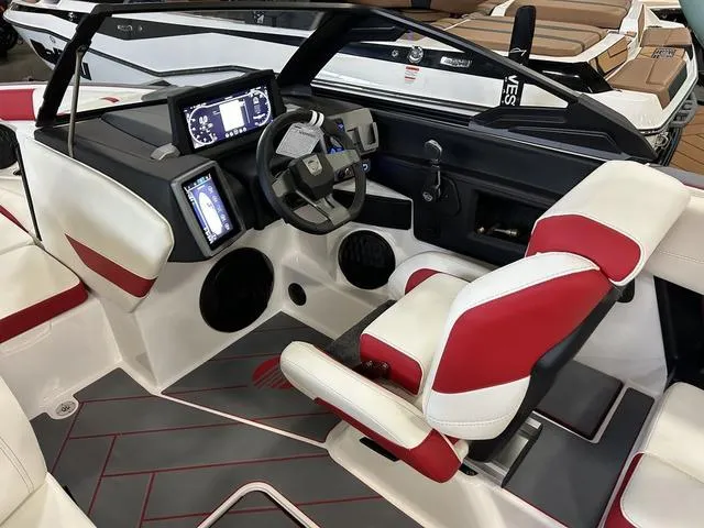 Slide: The Image of 2024 Malibu 22 LSV boat interior with modern dashboard and red-white seating. - 10