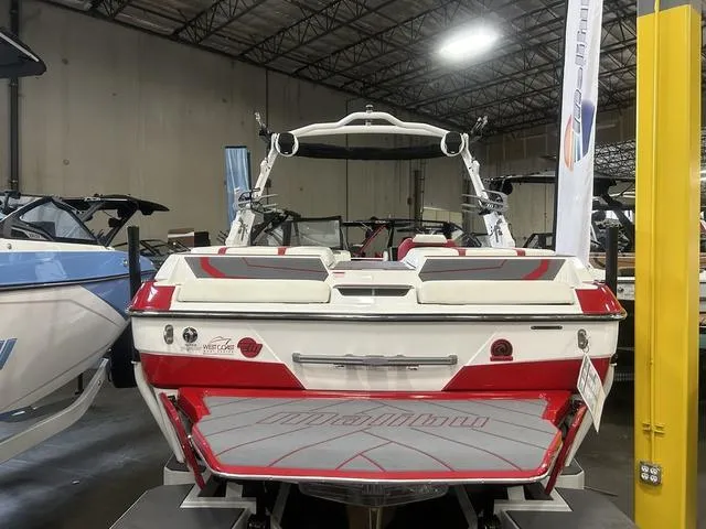 Slide: The Image of 2024 Malibu 22 LSV boat in showroom, rear view. - 12