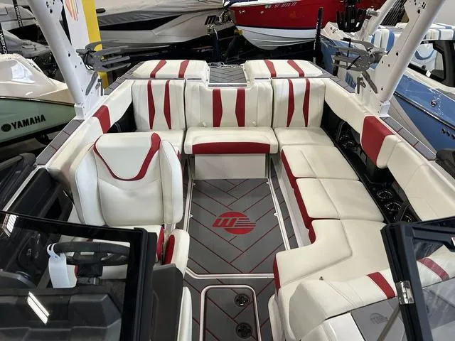 Slide: The Image of 2024 Malibu 22 LSV boat interior with white and red seating. - 4