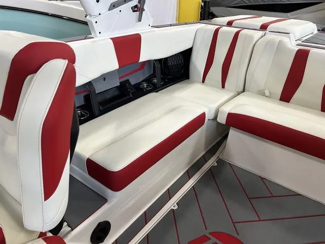 Slide: The Image of 2024 Malibu 22 LSV boat interior with red and white seating. - 6