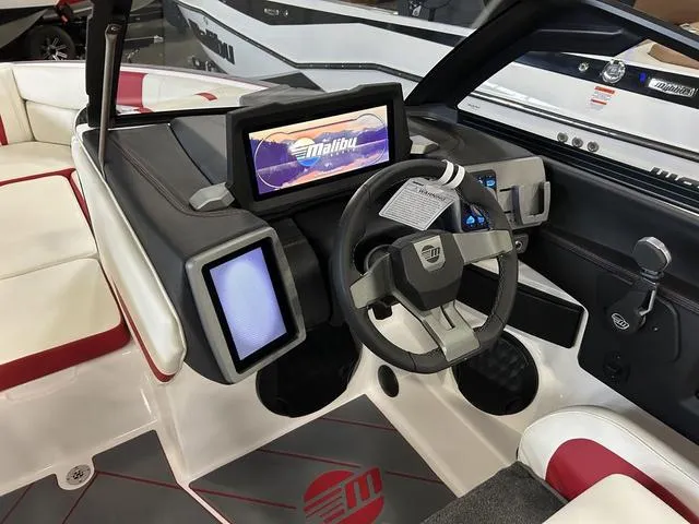 Slide: The Image of 2024 Malibu 22 LSV boat interior with advanced dashboard and steering wheel. - 8