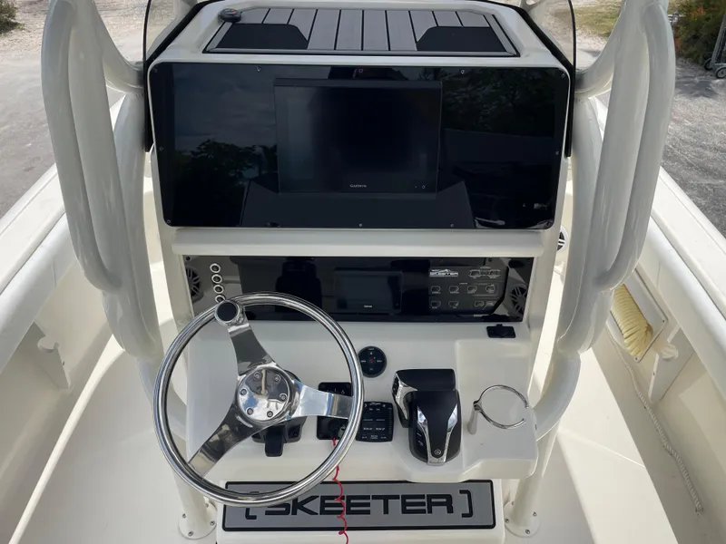 Slide: The Image of 2022 Skeeter 2550 Family boat console with steering wheel and electronic controls. - 12