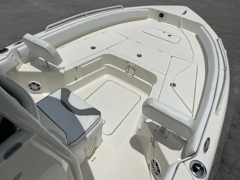 Slide: The Image of 2022 Skeeter 2550 Family boat interior with white seating and storage compartments. - 13