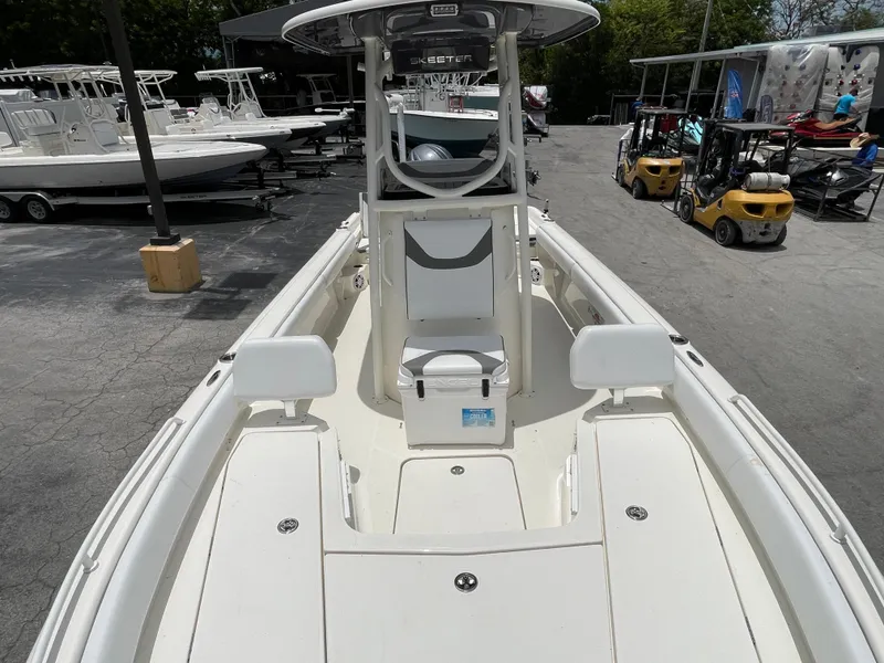 Slide: The Image of 2022 Skeeter 2550 Family boat, spacious deck, center console, white exterior, docked at marina. - 16