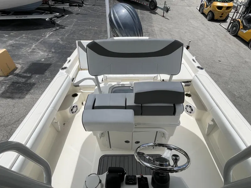 Slide: The Image of 2022 Skeeter 2550 Family boat interior with dual seating and steering console. - 18