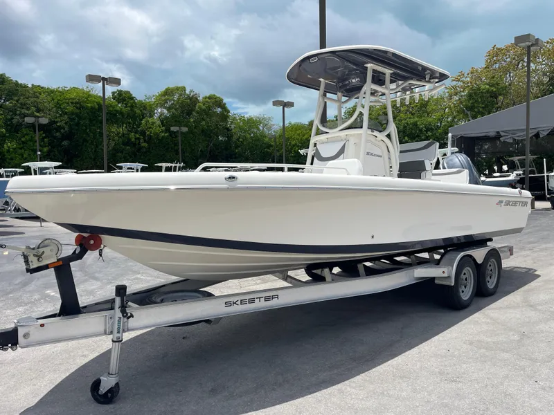 Slide: The Image of 2022 Skeeter 2550 Family boat on a trailer, parked outdoors. - 4
