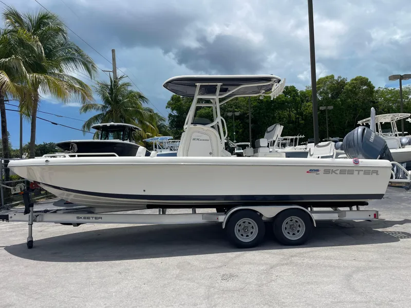 Slide: The Image of 2022 Skeeter 2550 Family boat on trailer, parked outdoors. - 5