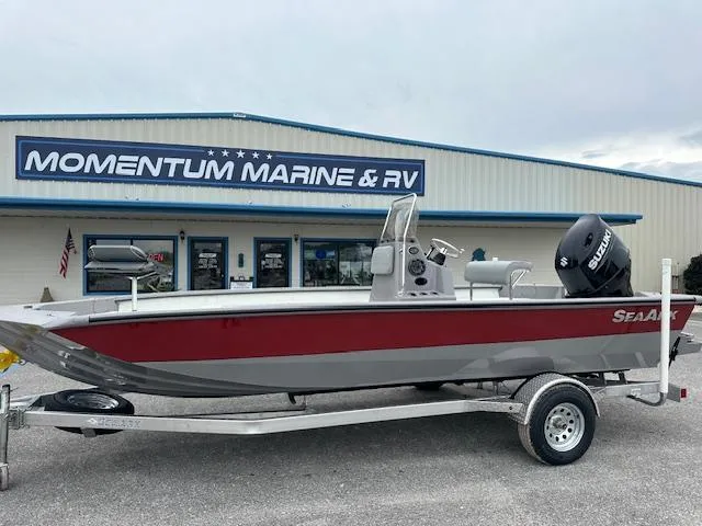 The Image of 2024 SeaArk Bay Runner 210 boat on trailer at Momentum Marine & RV dealership. - 1