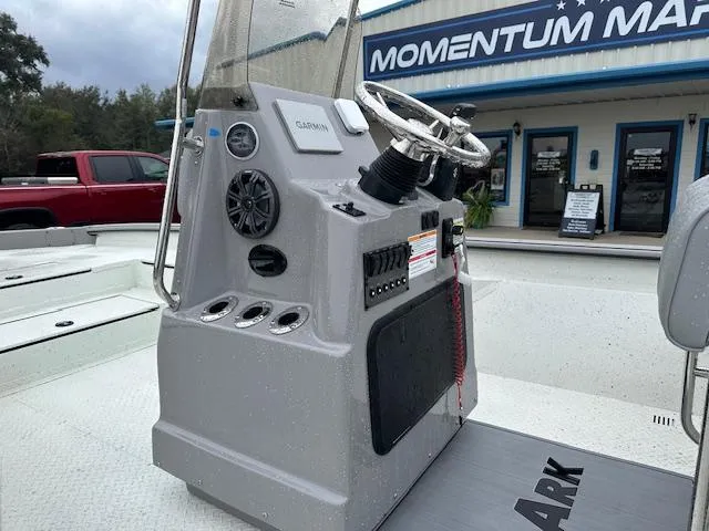 Slide: The Image of 2024 SeaArk Bay Runner 210 boat console with steering wheel and controls. - 4