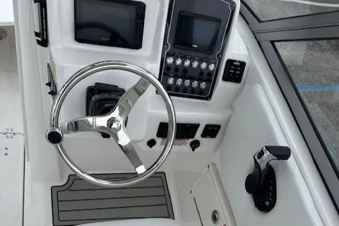 Slide: The Image of 2024 Sea Fox 228 Traveler boat dashboard with steering wheel and control panel. - 7