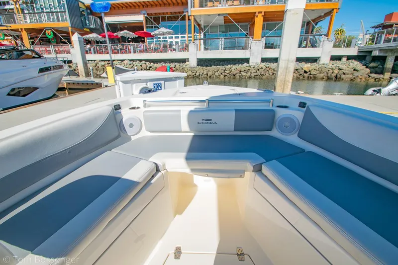 Slide: The Image of 2018 Cobia 240 CC boat interior at a marina dock. - 10
