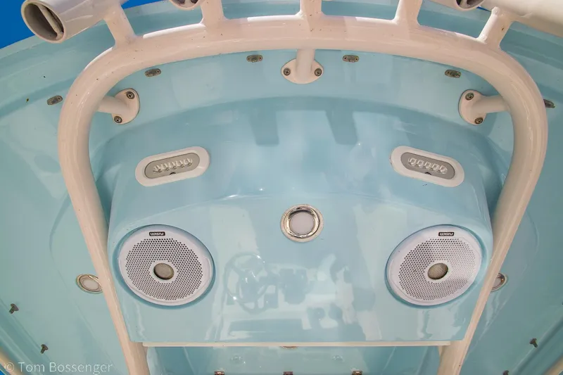 Slide: The Image of 2018 Cobia 240 CC boat speakers and canopy, featuring a sleek blue design. - 20