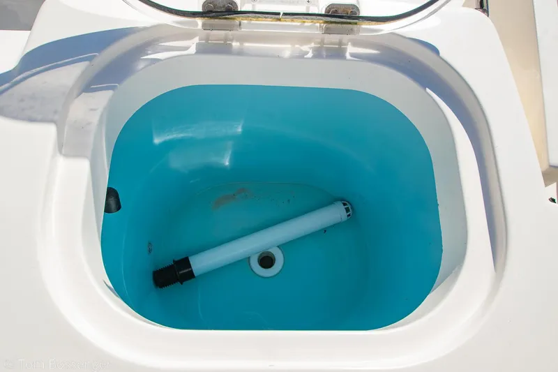 Slide: The Image of Livewell compartment on a 2018 Cobia 240 CC boat, featuring a blue interior. - 22