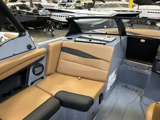 Slide: The Image of 2024 Axis Wake Research A225 boat interior with tan and black seating. - 4