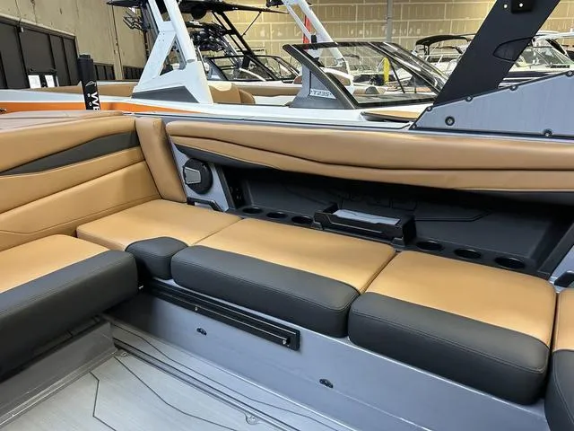 Slide: The Image of 2024 Axis Wake Research A225 boat interior with tan and black seating. - 5