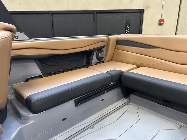 Slide: The Image of 2024 Axis Wake Research A225 boat interior with tan and black seating. - 6