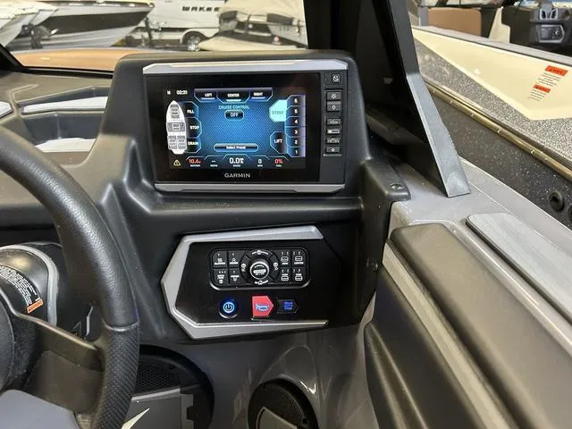 Slide: The Image of 2024 Axis Wake Research A225 boat dashboard with Garmin display and control panel. - 7