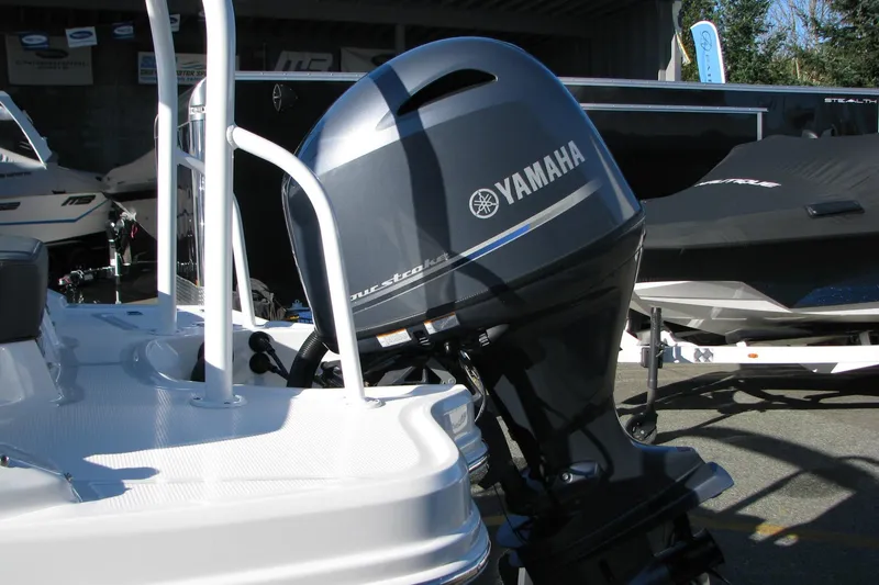 Slide: The Image of 2024 Chaparral 19 SSi OB with Yamaha outboard motor in a showroom. - 19