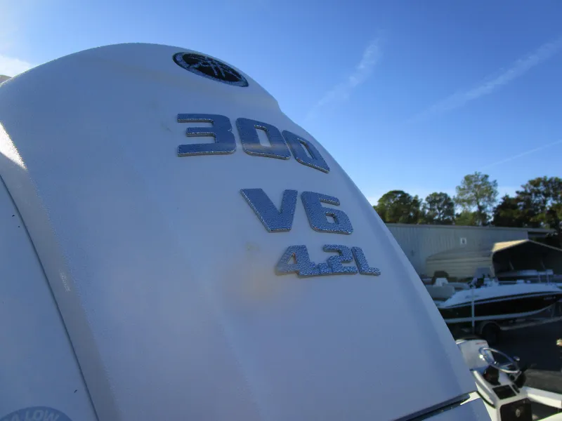 Slide: The Image of 2024 Cobia 240 CC boat engine, 300 V6 4.2L, outdoor setting. - 2