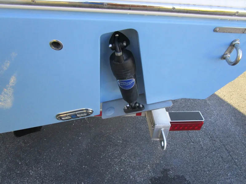 Slide: The Image of 2024 Cobia 240 CC boat transom with trim tab and trailer attachment. - 3