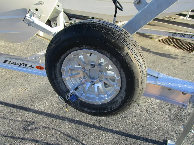 Slide: The Image of Trailer wheel of a 2024 Cobia 240 CC boat on AmeraTrail trailer. - 5