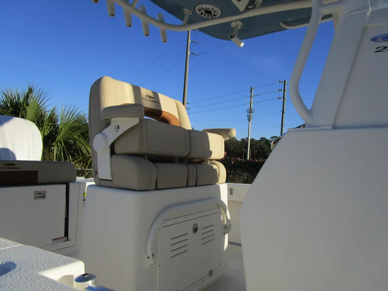 Slide: The Image of 2024 Cobia 240 CC boat interior with cushioned seating and storage compartments. - 7
