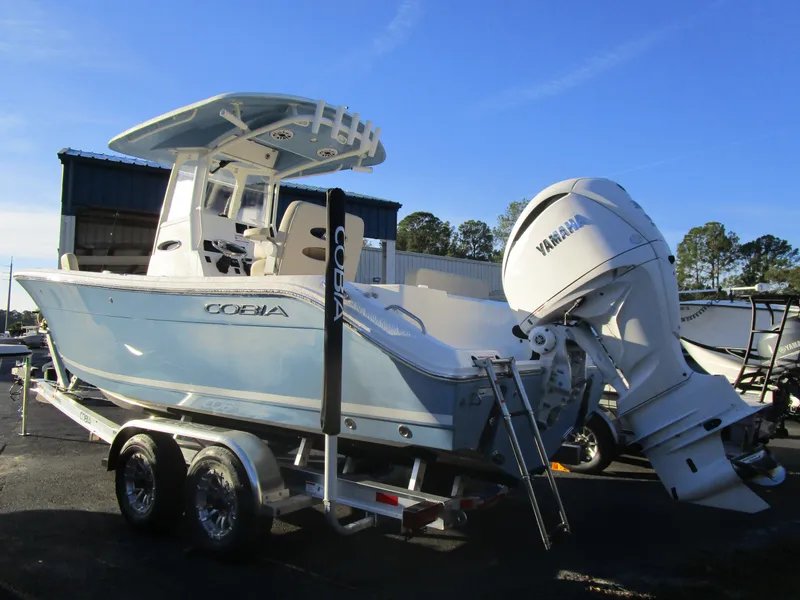 Slide: The Image of 2024 Cobia 240 CC boat with Yamaha engine on trailer, parked outdoors. - 8