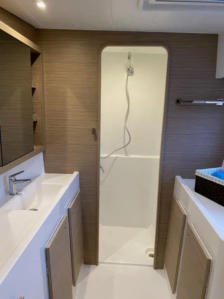Slide: The Image of Modern bathroom in 2024 Lagoon 42 catamaran with shower and dual sinks. - 10